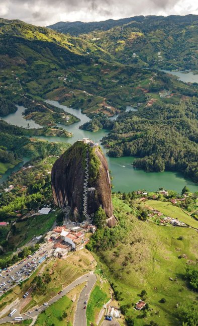 El Peñol, a huge granite monolith with a zigzag staircase up its face, standing over the green islands and inlets of the Guatapé reservoir.